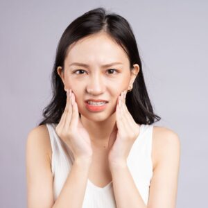 girl rubbing mouth
