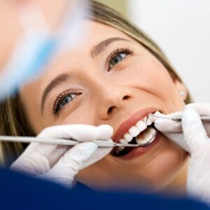 smiling woman getting tooth cleaning
