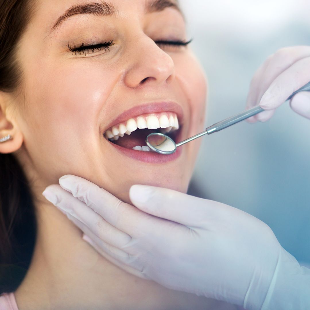 Woman getting her teeth cleaned by a dentist.