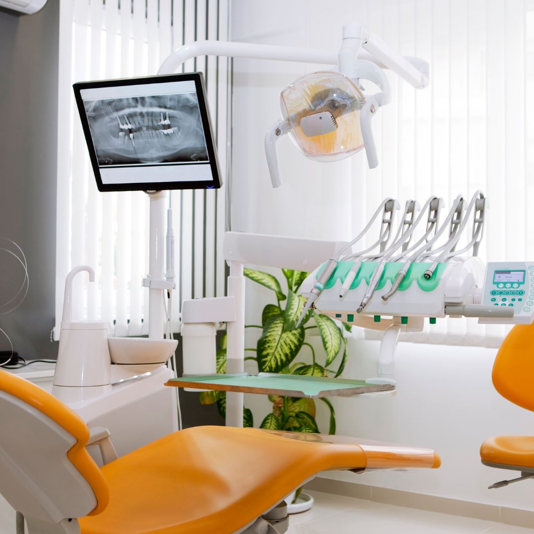 Dentist's chair, x-ray screen, and various cleaning tools and technology. 