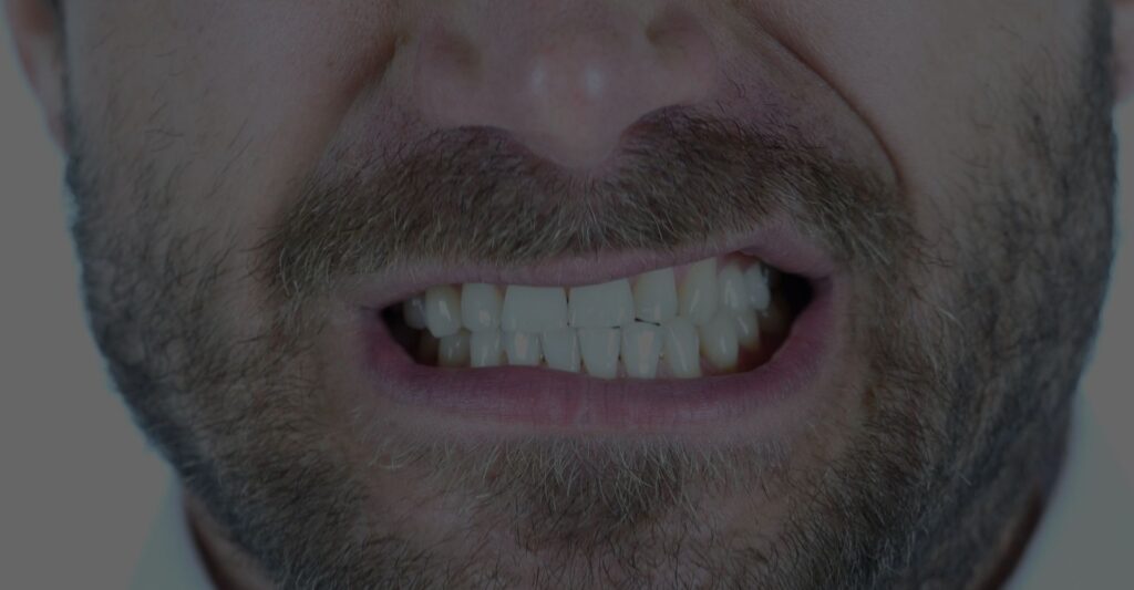man grinding his teeth