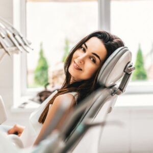 A dental patient leaning back in the dentist chair
