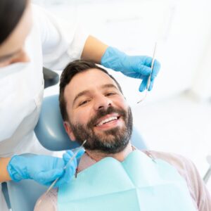 happy man during tooth cleaning procedure
