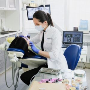 Dentist examining patient in a clinic with tools