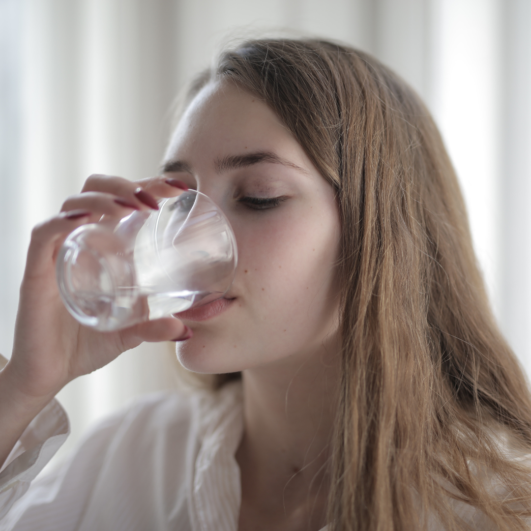 Woman drinking water.