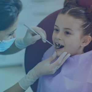 dentist inspecting girl's teeth