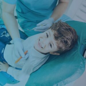 smiling kid in dentist's chair