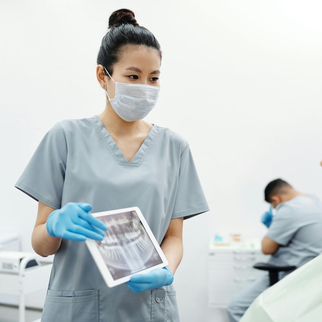 dentist holding screen with x-rays