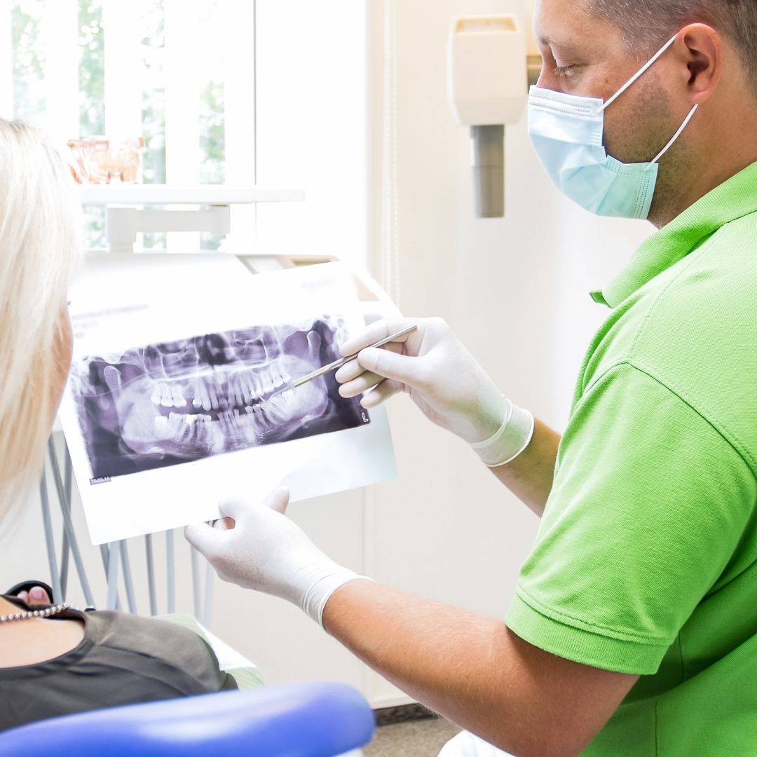 dentist going over x-ray with patient