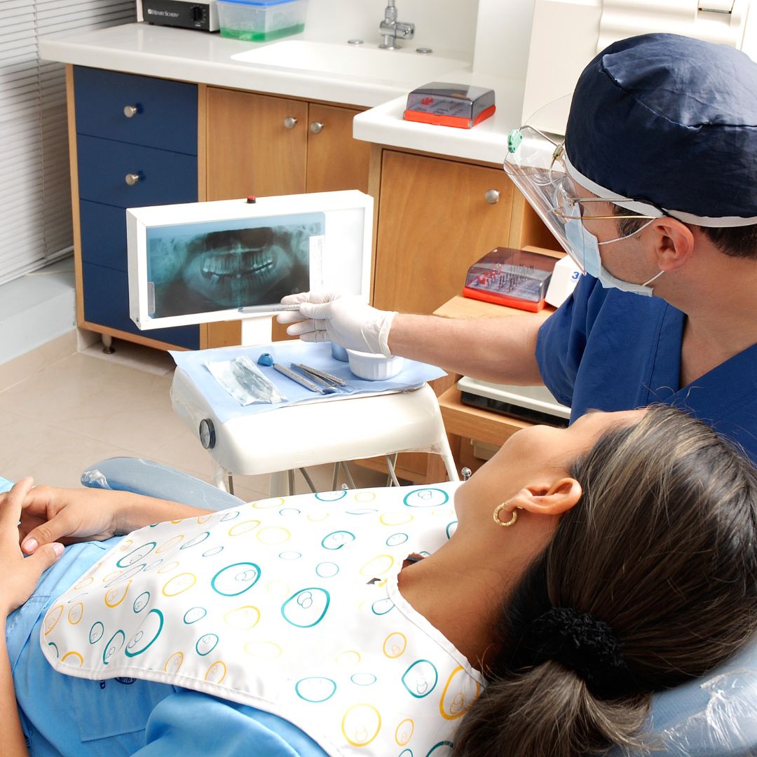 dentist going over x-ray with patient