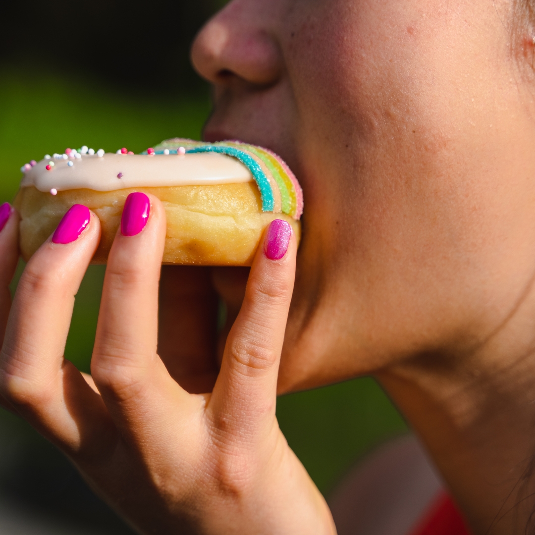 Woman biting into a donut